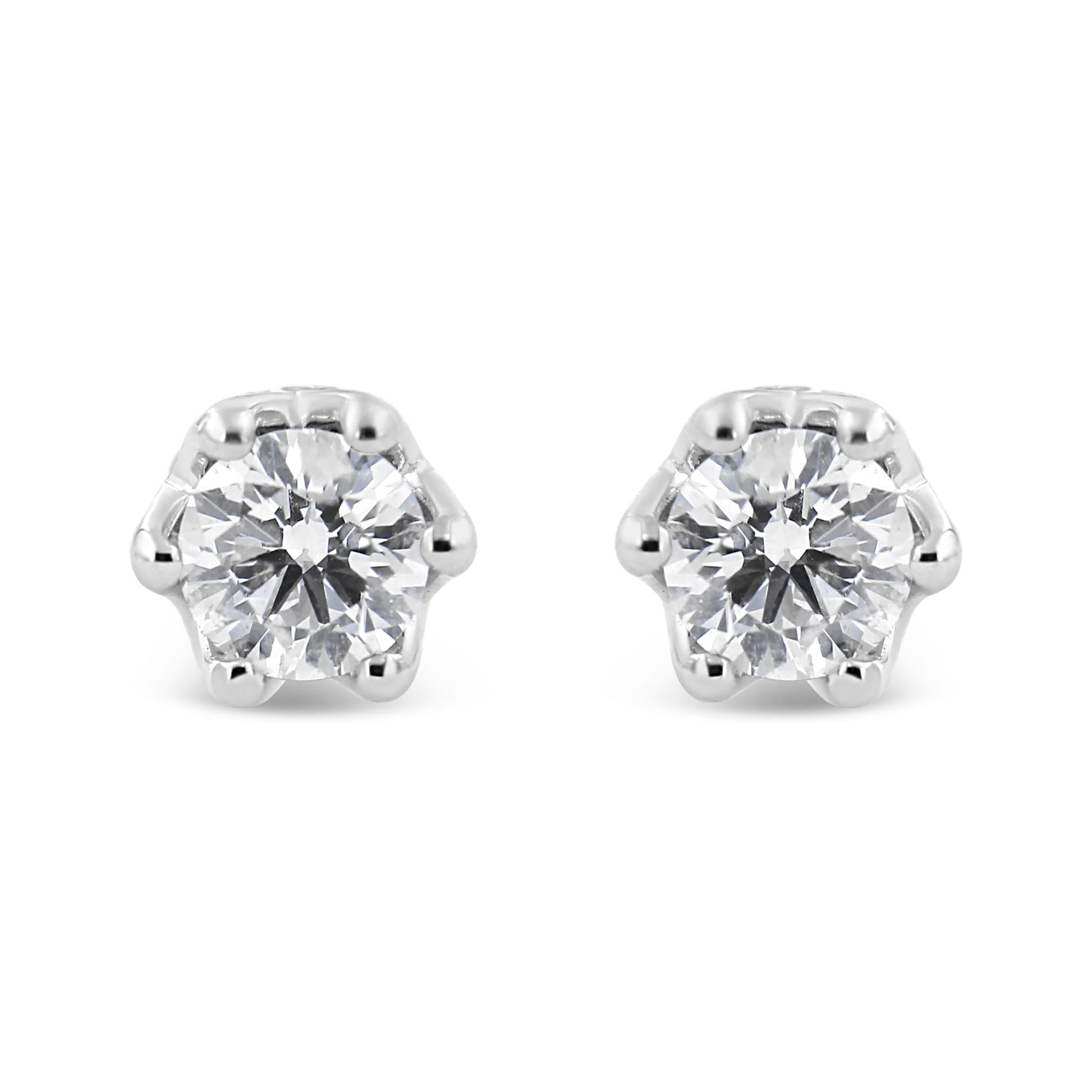 Front view of a pair of white metal stud earrings each featuring a round white gemstone in prong setting.