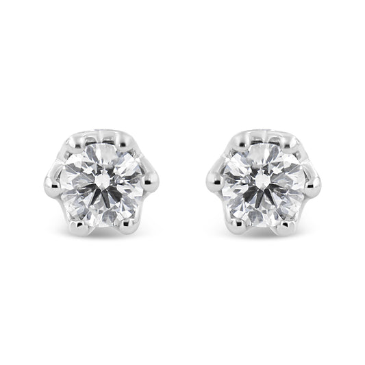 Front view of a pair of white metal stud earrings each featuring a round white gemstone in prong setting.