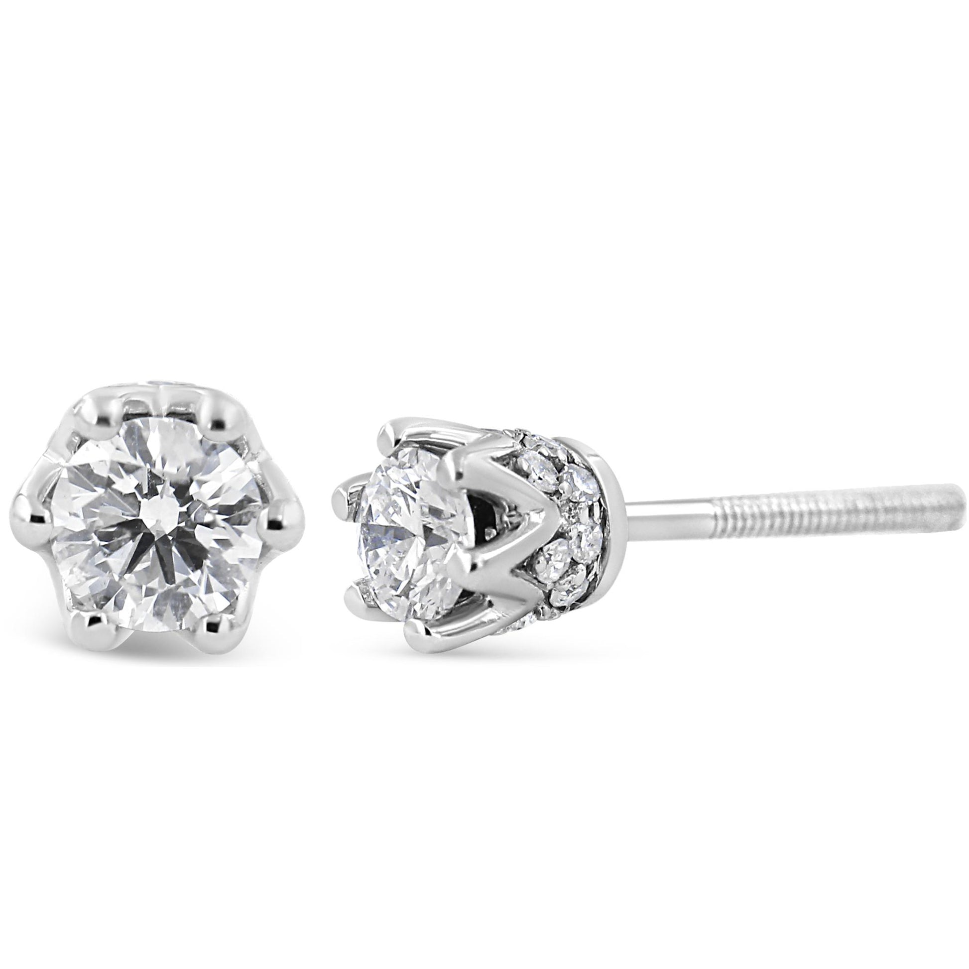 Close-up front and side view of a pair of white metal stud earrings with round white gemstones in prong settings and additional smaller round white gemstones in pave settings around the base.