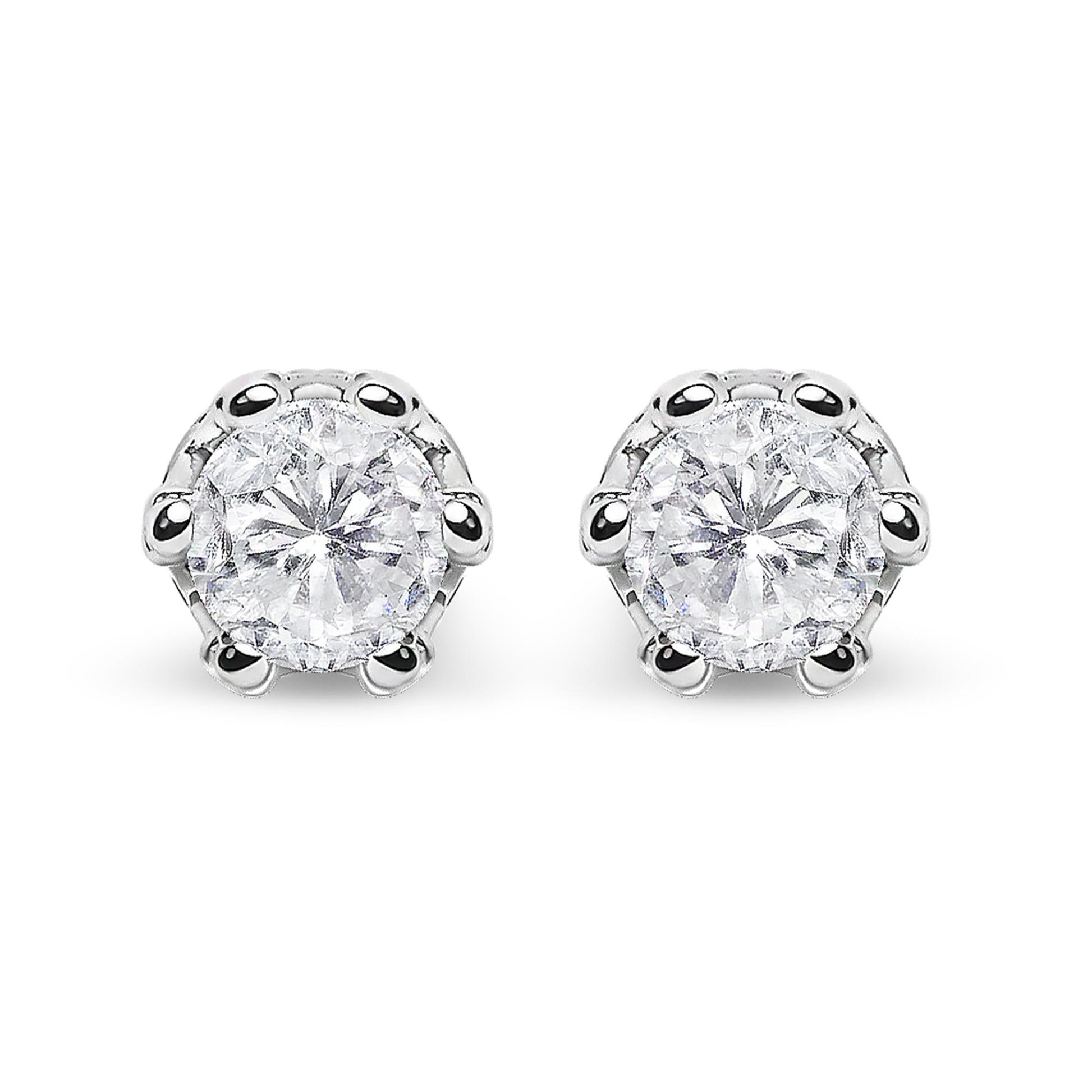 Front-facing close-up of a pair of white metal stud earrings featuring round white gemstones in prong settings with smaller round white gemstones in pave settings above.