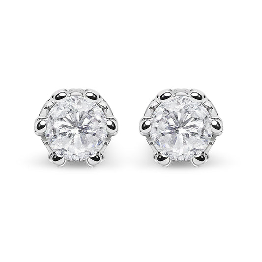 Front-facing close-up of a pair of white metal stud earrings featuring round white gemstones in prong settings with smaller round white gemstones in pave settings above.