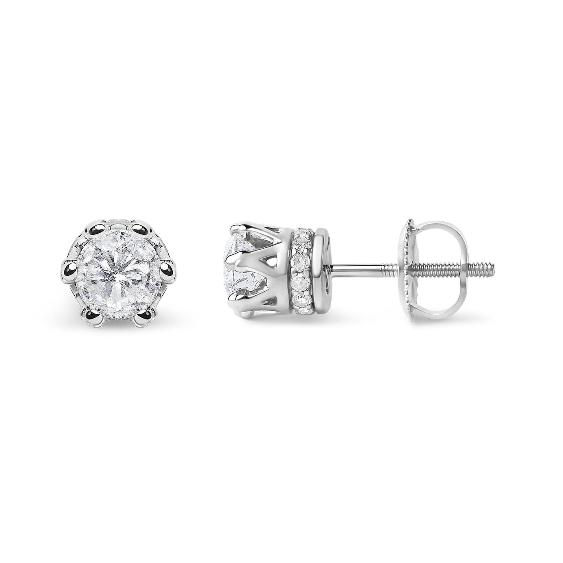Pair of white metal stud earrings with round prong-set white gemstones in front and smaller round pave-set white gemstones on the side, shown from front and side angles.