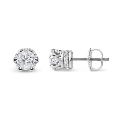 Pair of white metal stud earrings with round prong-set white gemstones in front and smaller round pave-set white gemstones on the side, shown from front and side angles.