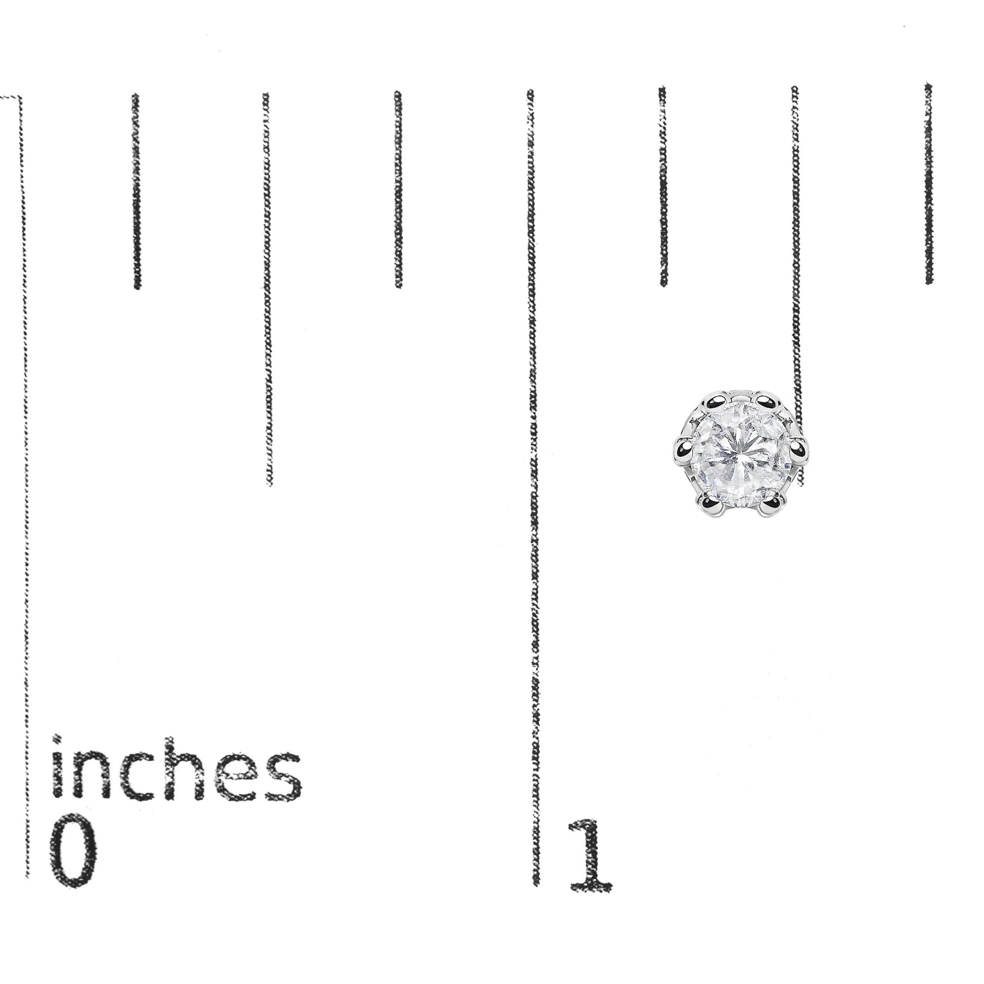 Close-up of a pair of white metal stud earrings with a large round prong-set white gemstone in the center, surrounded by smaller round pave-set white gemstones, shown on a ruler for size reference from a side and angled front view.