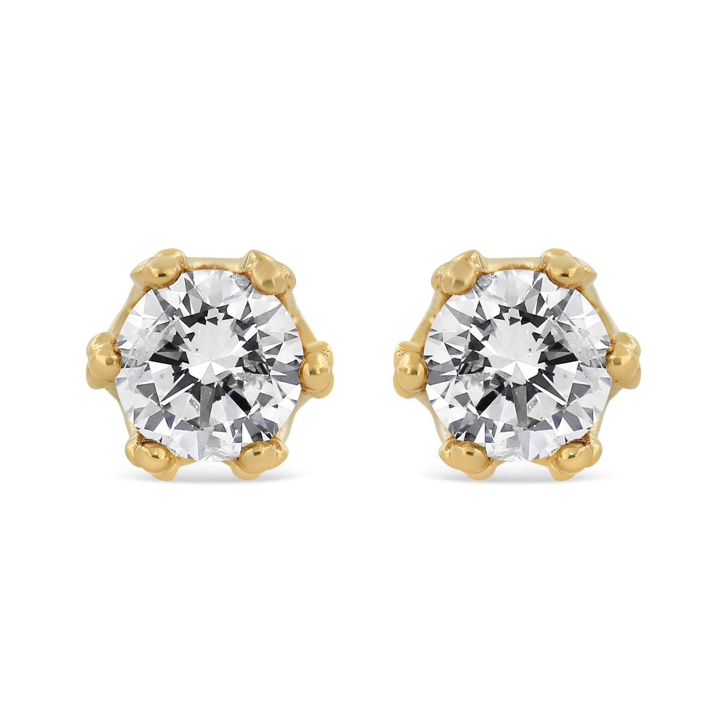 Front view of yellow metal stud earrings each featuring a large round white gemstone in prong setting.