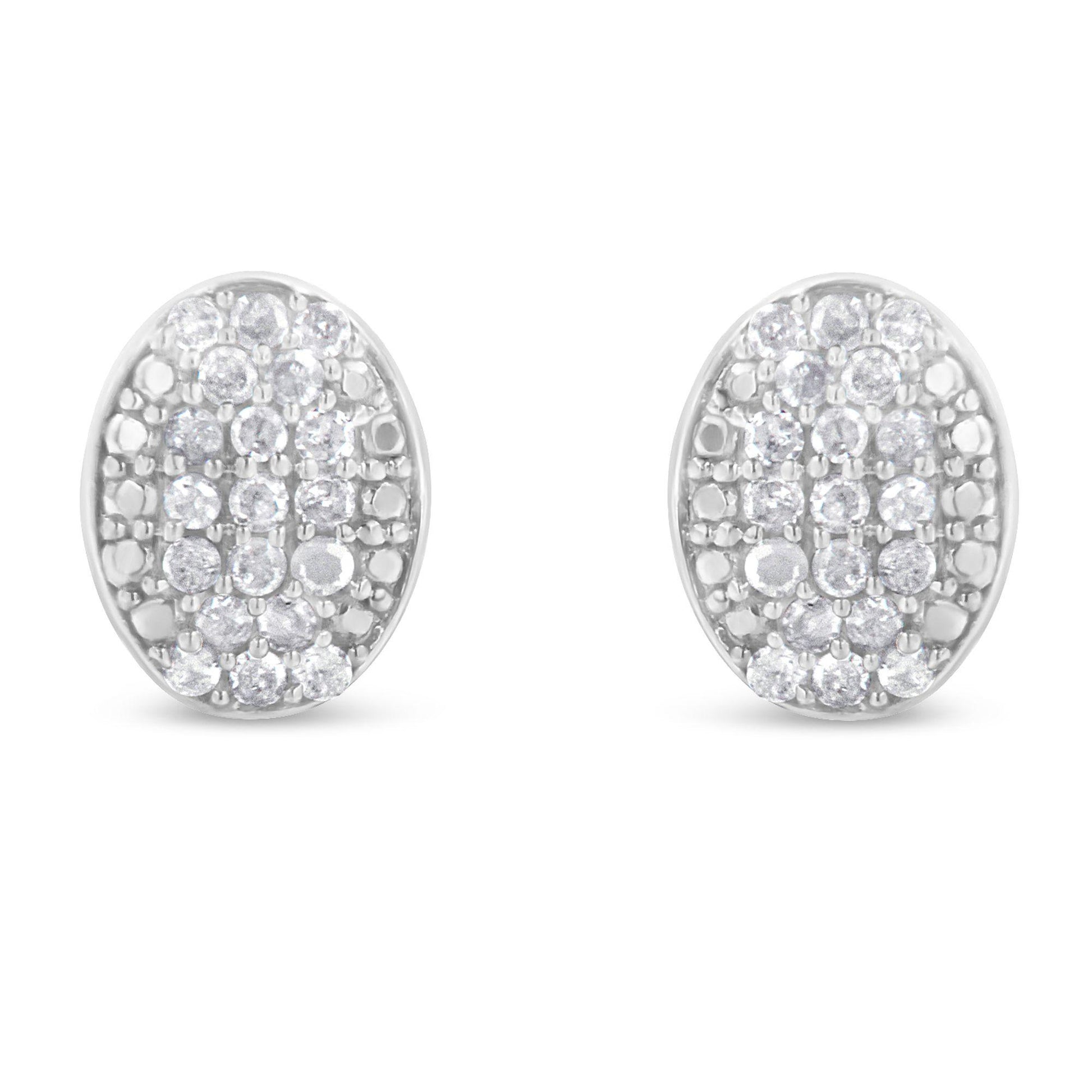 Front-facing view of a pair of white metal oval earrings featuring multiple round white gemstones in prong settings.