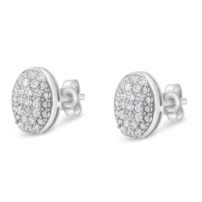Pair of white metal oval stud earrings with multiple round white gemstones in prong settings, shown from a front-side angle.