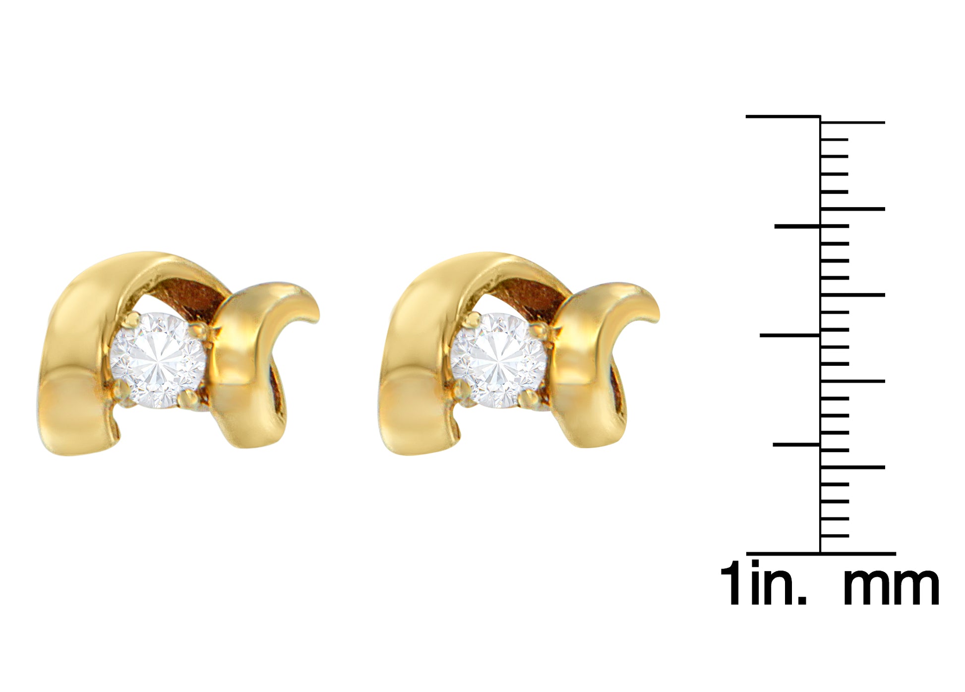 Close-up front view of yellow metal earrings with round white gemstones in prong settings, shown next to a ruler for size reference.