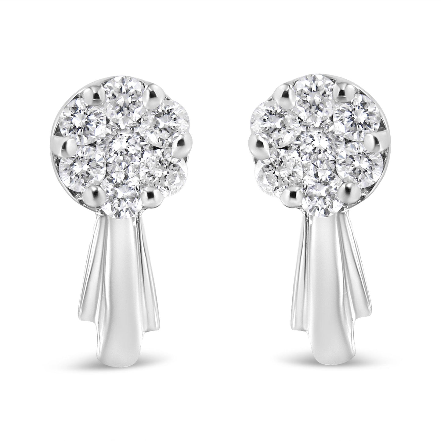 Front-facing shot of a pair of white metal earrings with clusters of round white gemstones in prong settings at the top and smooth elongated drops below.
