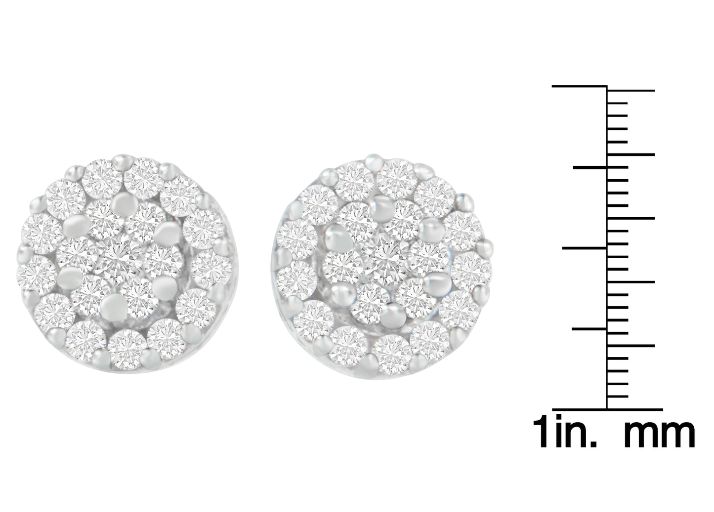 Close-up front view of round white metal earrings with clustered white gemstones in prong settings, shown next to a ruler for size reference.