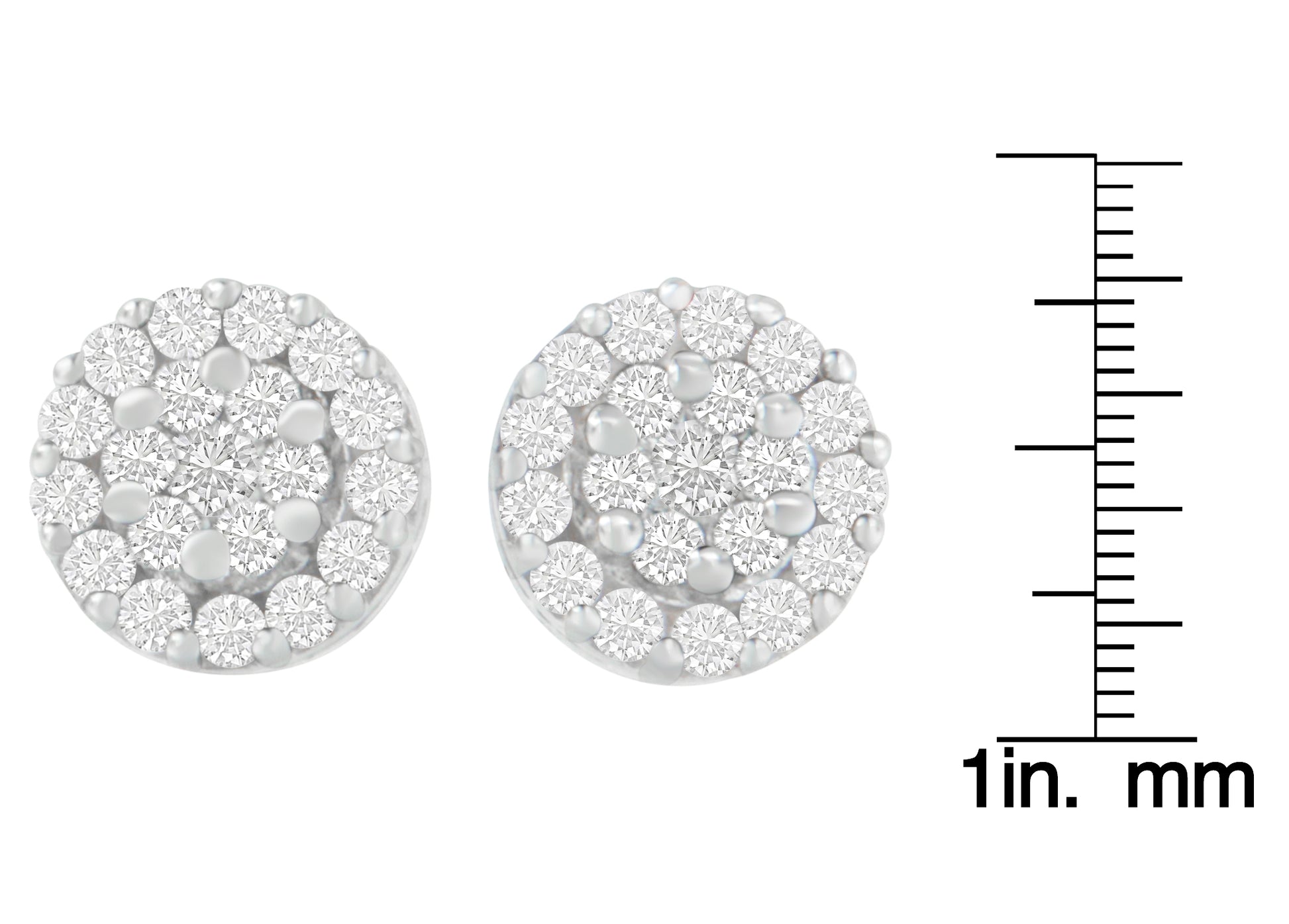 Close-up front view of round white metal earrings with clustered white gemstones in prong settings, shown next to a ruler for size reference.