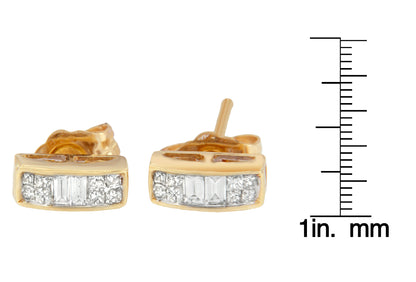 Pair of yellow metal earrings with white baguette and princess shape gemstones, shown from the front on a ruler for size reference.