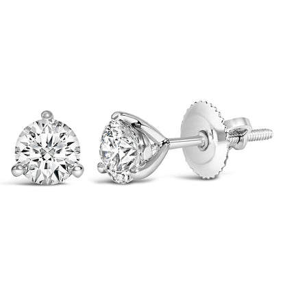 Close-up of a pair of white metal stud earrings with round white gemstones in a 3-prong setting, shown from front and side angles on a white background.