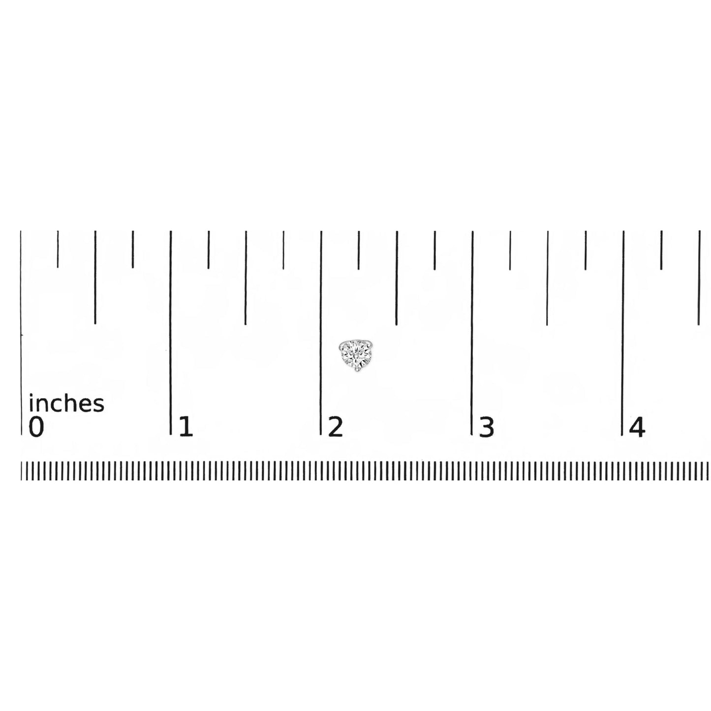 Close-up of a white metal stud earring with a round white gemstone in a three-prong setting, placed on a ruler for size reference.