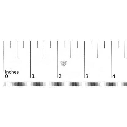 Close-up of a white metal stud earring with a round white gemstone in a three-prong setting, placed on a ruler for size reference.