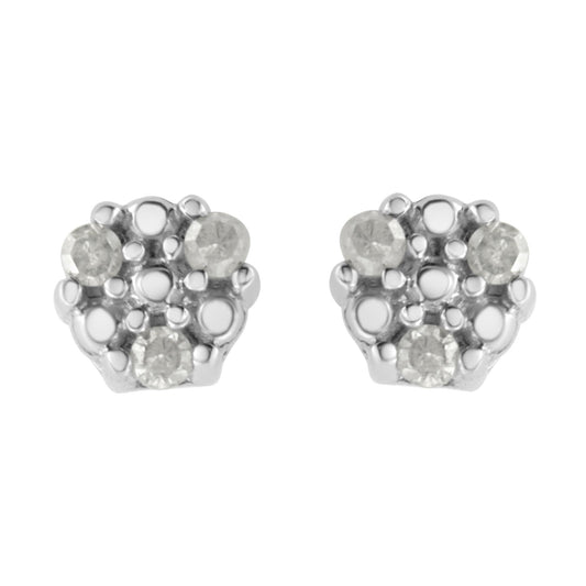 Front view of a pair of white metal stud earrings with multiple round white gemstones in prong settings.