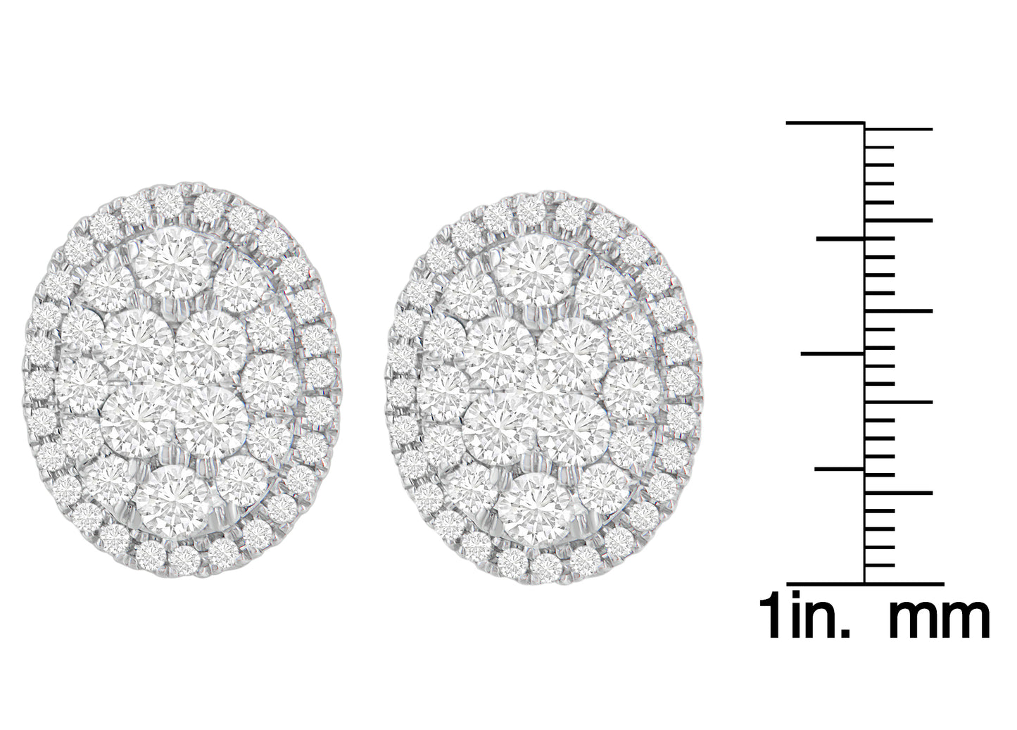 Pair of yellow metal oval earrings set with multiple round white gemstones in prong settings, shown from front on with a ruler for size reference.