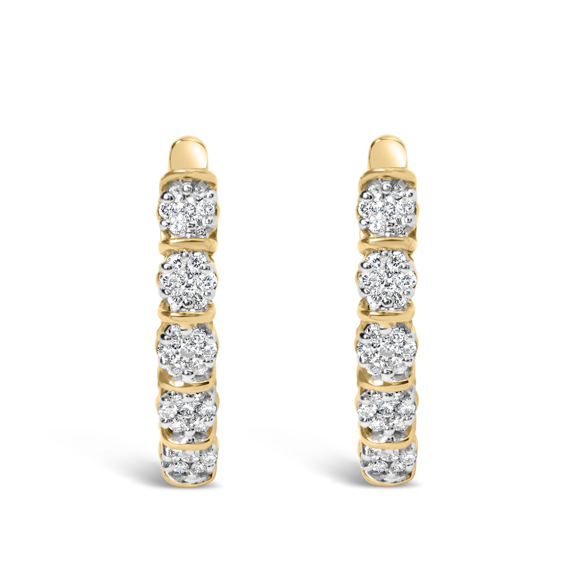 Front view of a pair of yellow metal hoop earrings featuring multiple round white gemstones in prong settings along the outer edge.