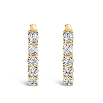 Front view of a pair of yellow metal hoop earrings featuring multiple round white gemstones in prong settings along the outer edge.