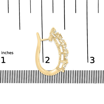 Yellow metal earring with curved arch design and prong-set round white gemstones, shown on a scale from the side angle.