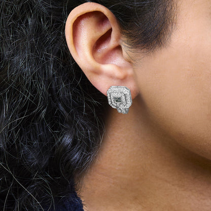 Close-up side view of a white metal earring with round white gemstones in a pave setting surrounding a cluster of blue gemstones in an invisible setting, worn on a model's ear.