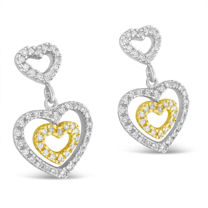 Front angled view of two-toned heart-shaped earrings featuring white round pave-set gemstones outlining both the outer and inner hearts.