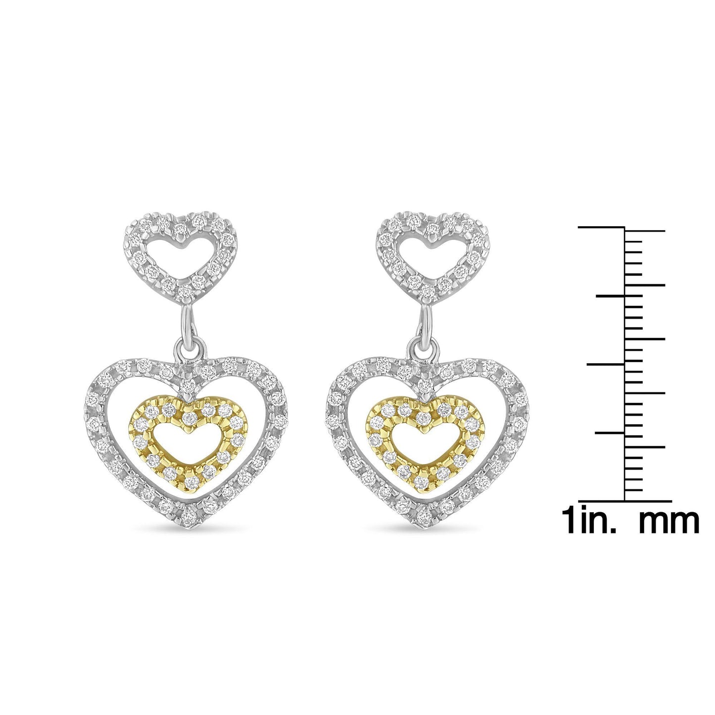 Front view of two-toned heart-shaped dangling earrings with pave set round white gemstones, displayed next to a ruler for size reference.