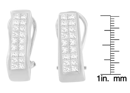 Pair of white metal earrings with rows of princess-shaped white gemstones in an invisible setting, shown from a front angle next to a ruler for size reference.