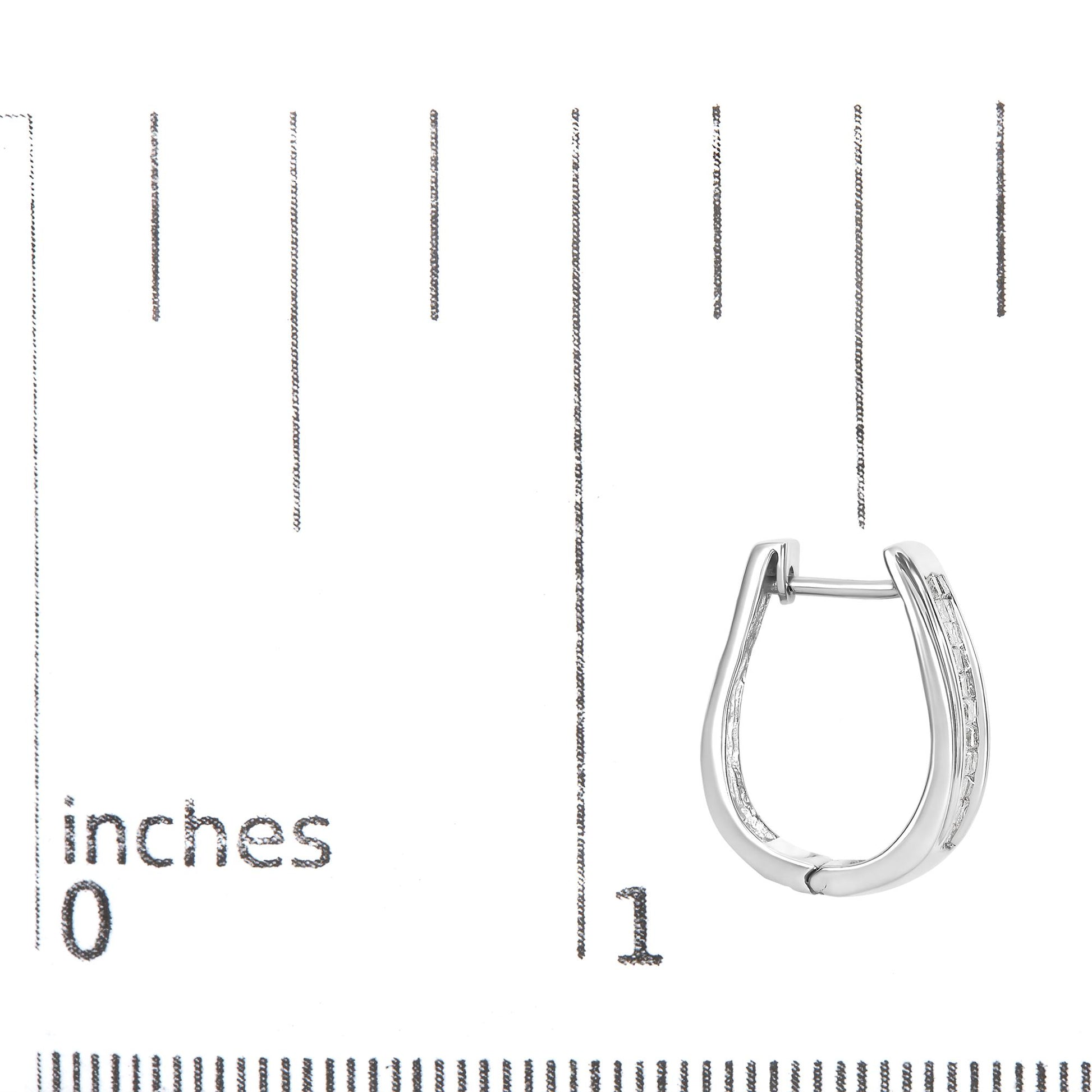 Earring shown on a scale, front angle, white metal hoop with rows of princess-shaped white gemstones in invisible setting on outer edge.