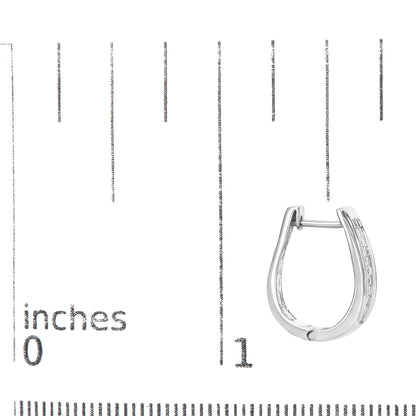 Earring shown on a scale, front angle, white metal hoop with rows of princess-shaped white gemstones in invisible setting on outer edge.