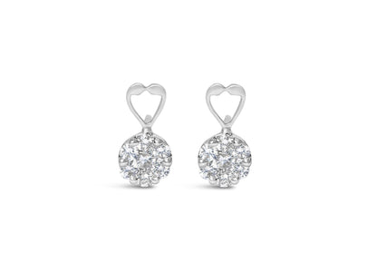 Front view of white metal earrings with heart shaped top and cluster of round prong-set white gemstones.