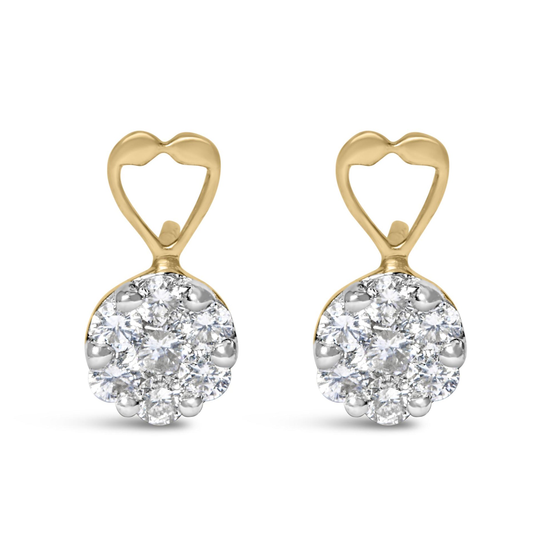 Front view of yellow metal earrings with heart-shaped tops and round clusters of white gemstones in prong settings.
