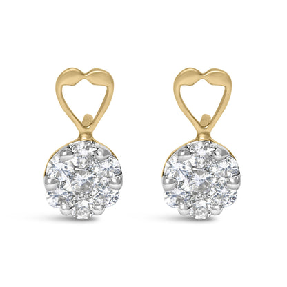 Front view of yellow metal earrings with heart-shaped tops and round clusters of white gemstones in prong settings.