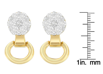 Front view of yellow metal earrings with round white gemstones in prong settings, shown next to a ruler for size reference.