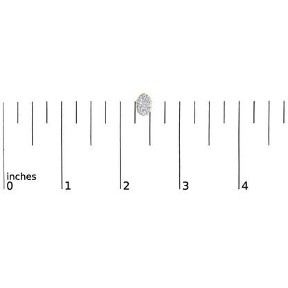 Close-up shot of a yellow metal earring with multiple round white gemstones in prong settings, placed on a ruler for size reference.