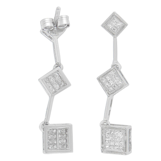 Front and side angled view of a pair of white metal dangle earrings with three connected square sections, each set with multiple white gemstones in a princess shape invisible setting.