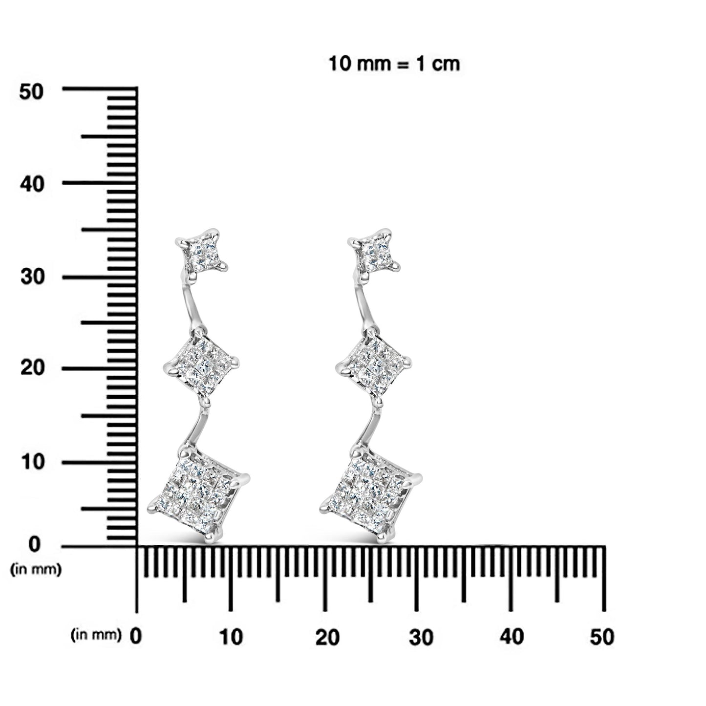 Pair of white metal earrings with three connected square clusters of white gemstones in a descending arrangement, displayed front-facing on a ruler for size reference.