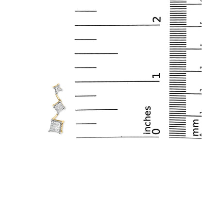Yellow metal earring with three descending princess-shaped clusters of white gemstones in an invisible setting, photographed on a ruler for size reference.