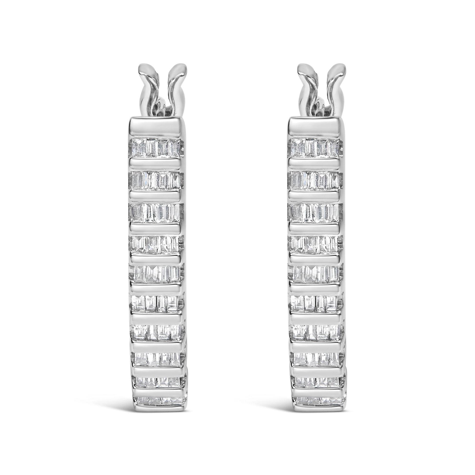 Front-facing view of a pair of white metal hoop earrings with multiple rows of channel-set baguette-shaped white gemstones.
