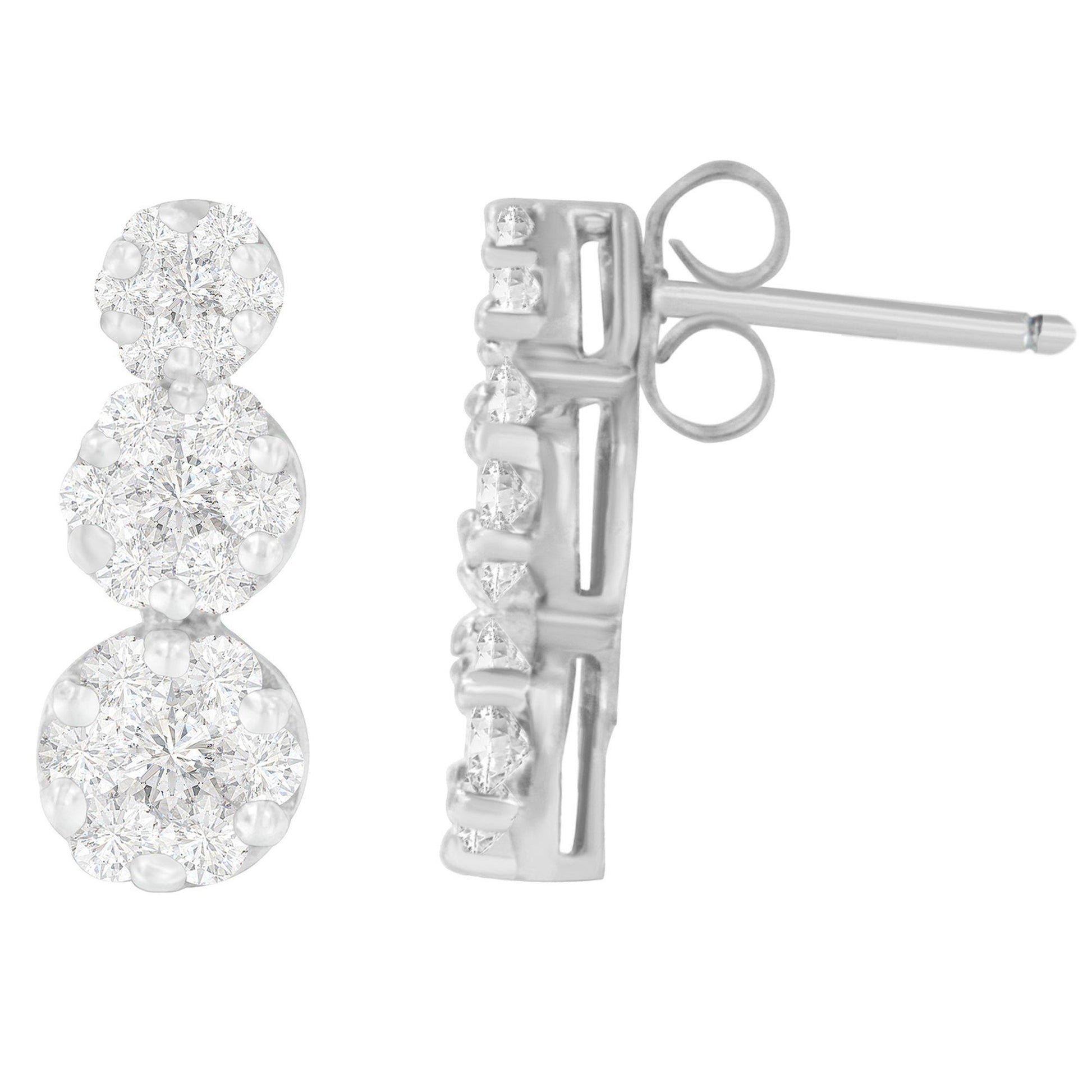 Close-up front and side views of white metal earrings with round white gemstones in prong settings.