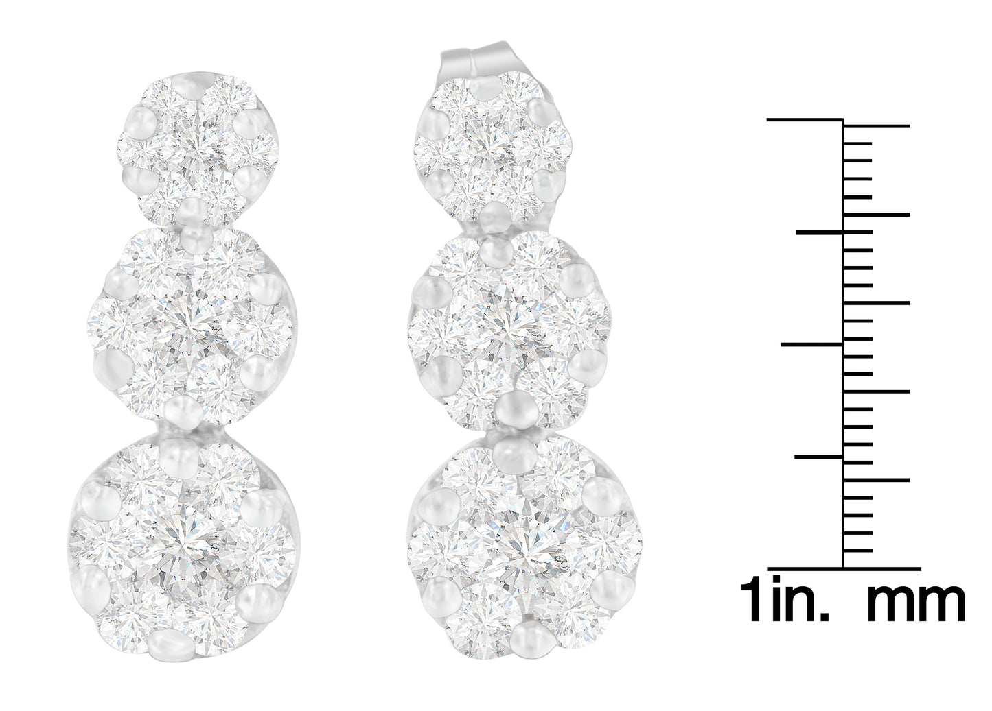 Front view of white metal triple cluster earrings with round white gemstones in prong settings, displayed next to a scale.