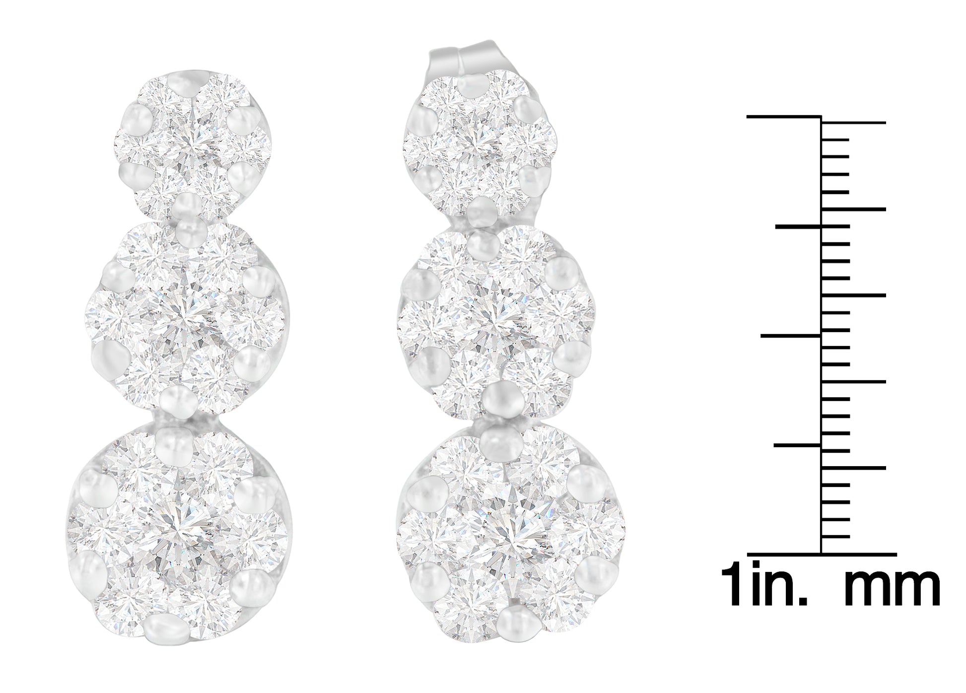 Front view of white metal triple cluster earrings with round white gemstones in prong settings, displayed next to a scale.