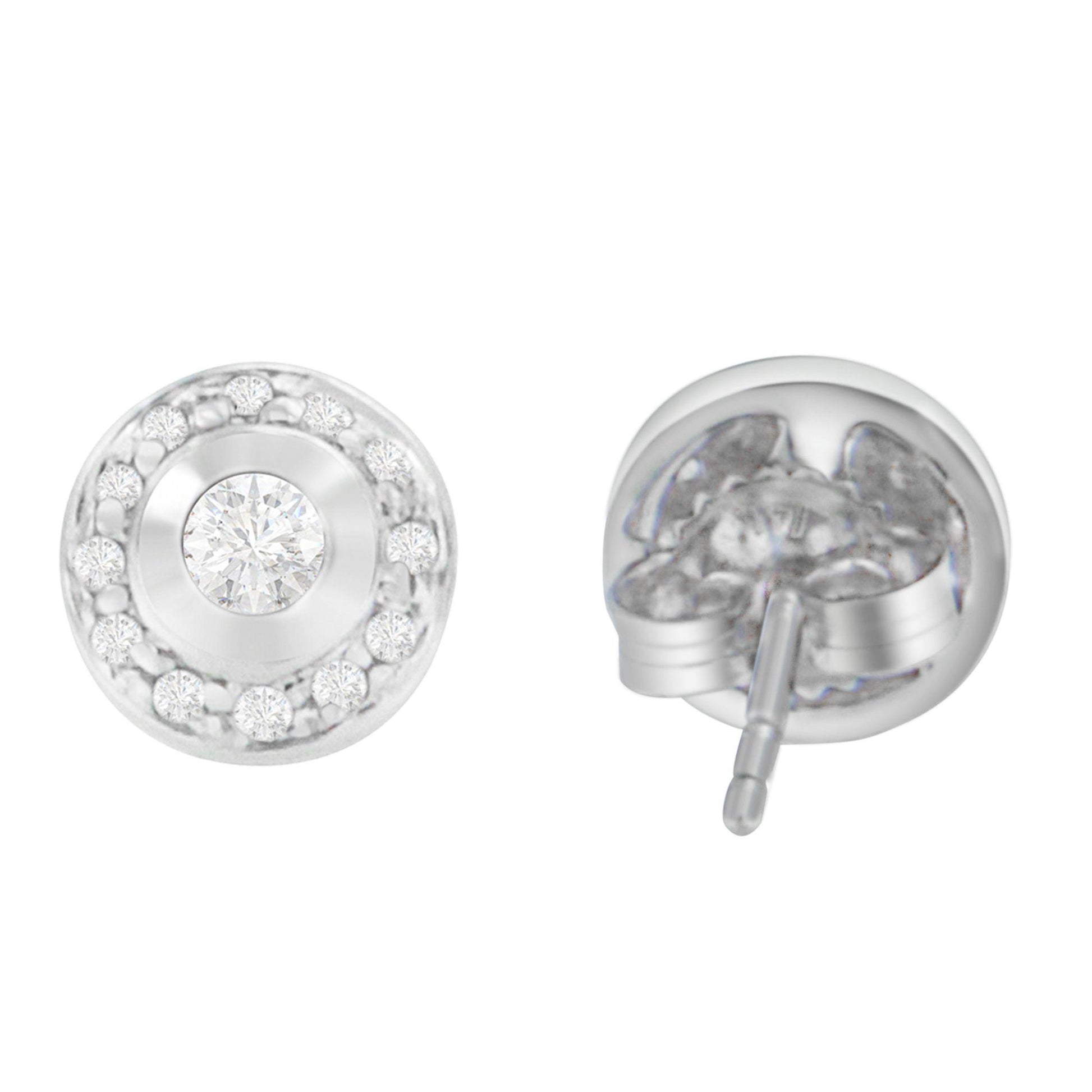 Front and back angled view of round white metal stud earrings with central round white gemstone in bezel setting surrounded by smaller round white gemstones in prong settings.