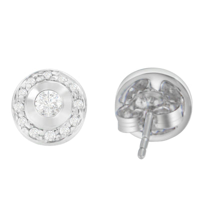 Front and back angled view of round white metal stud earrings with central round white gemstone in bezel setting surrounded by smaller round white gemstones in prong settings.