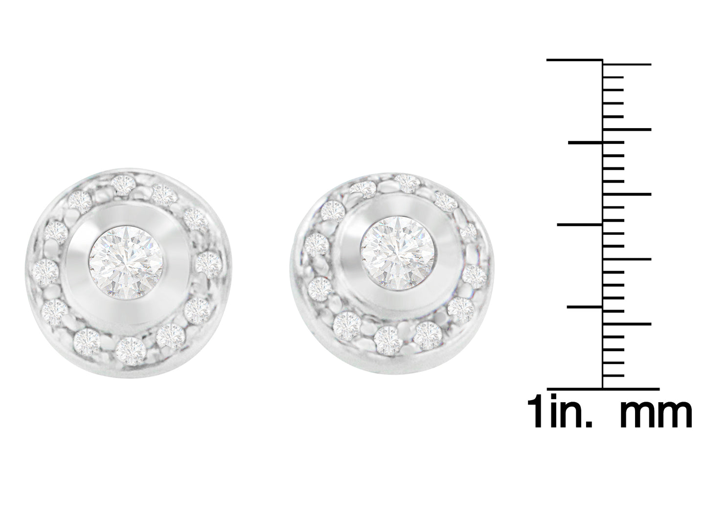 Front-facing view of a pair of white metal round earrings with central white gemstones in bezel settings surrounded by smaller white gemstones in prong settings, shown on a ruler for size reference.