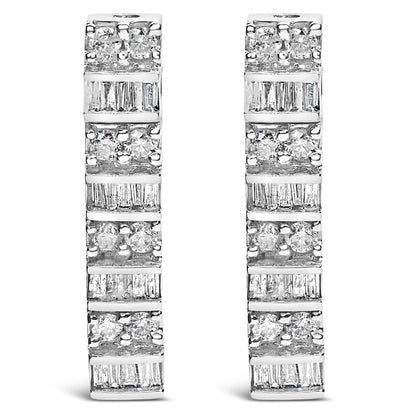 Front-facing view of white metal earrings with alternating rows of round white gemstones in prong settings and baguette white gemstones in channel settings.
