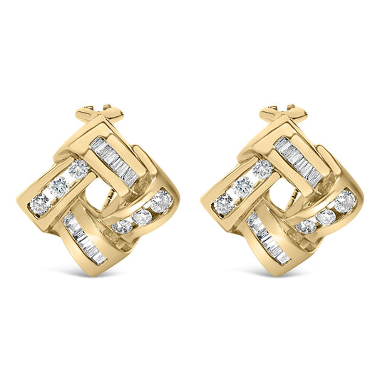 Pair of yellow metal earrings with an interwoven geometric design, featuring round and baguette white gemstones in channel settings, shown from a front angle.