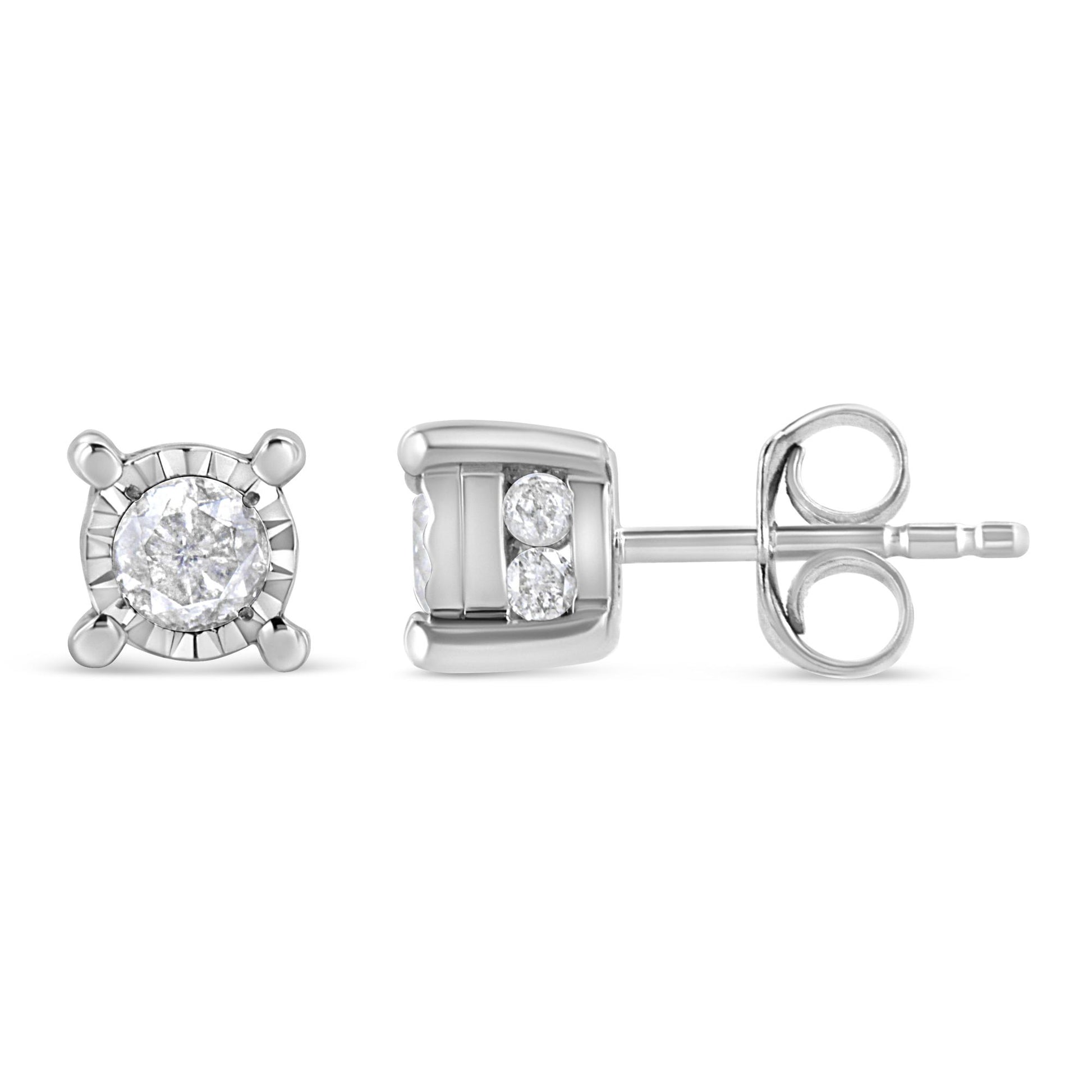 Pair of white metal stud earrings shown from front and side angles, featuring one round white gemstone in a miracle setting and two smaller round white gemstones in a channel setting on each earring.