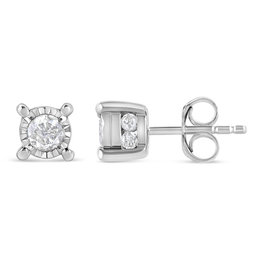 Pair of white metal stud earrings shown from front and side angles, featuring one round white gemstone in a miracle setting and two smaller round white gemstones in a channel setting on each earring.
