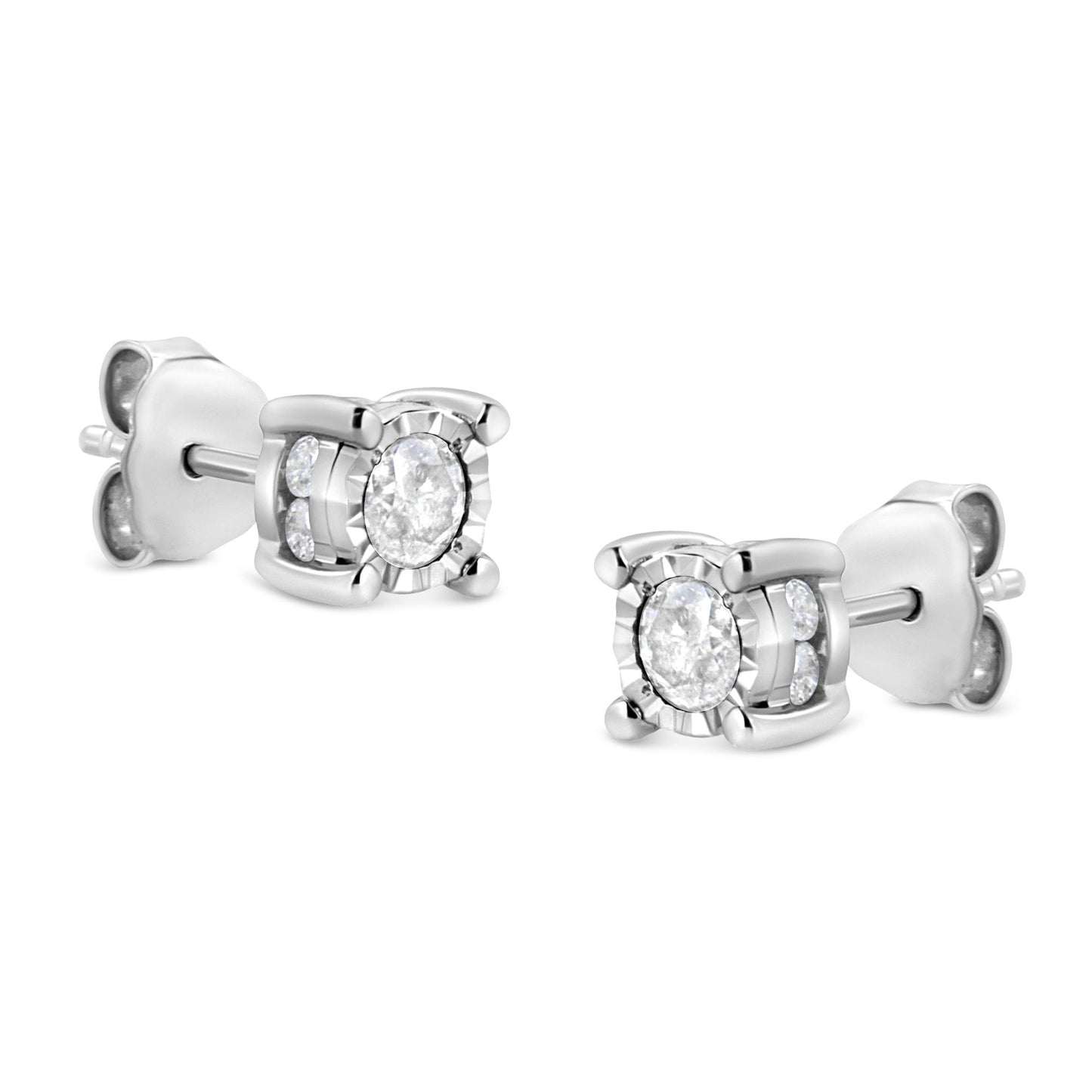 Pair of white metal stud earrings with round white gemstones in miracle and channel settings, shown at a slight angle.